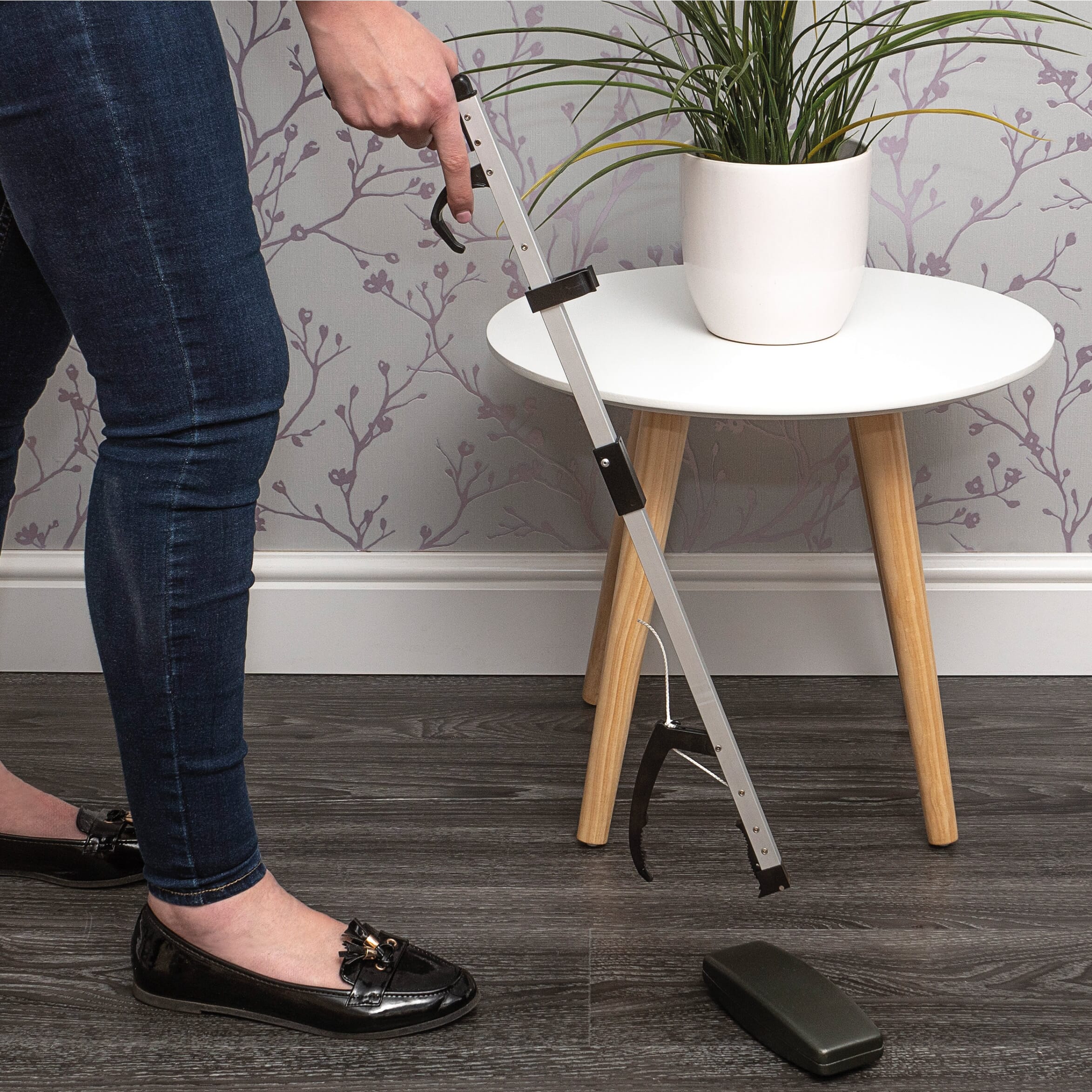 aluminium folding reacher in use picking from floor