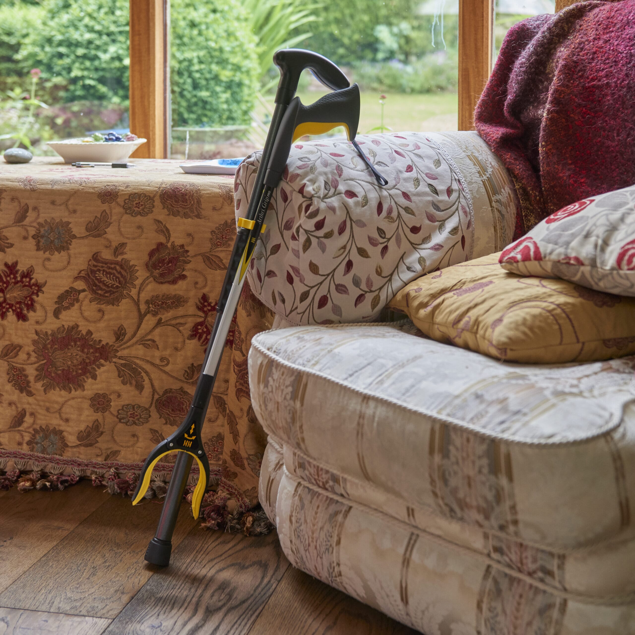 arthri grip pro reacher grabber attached to a walking stick