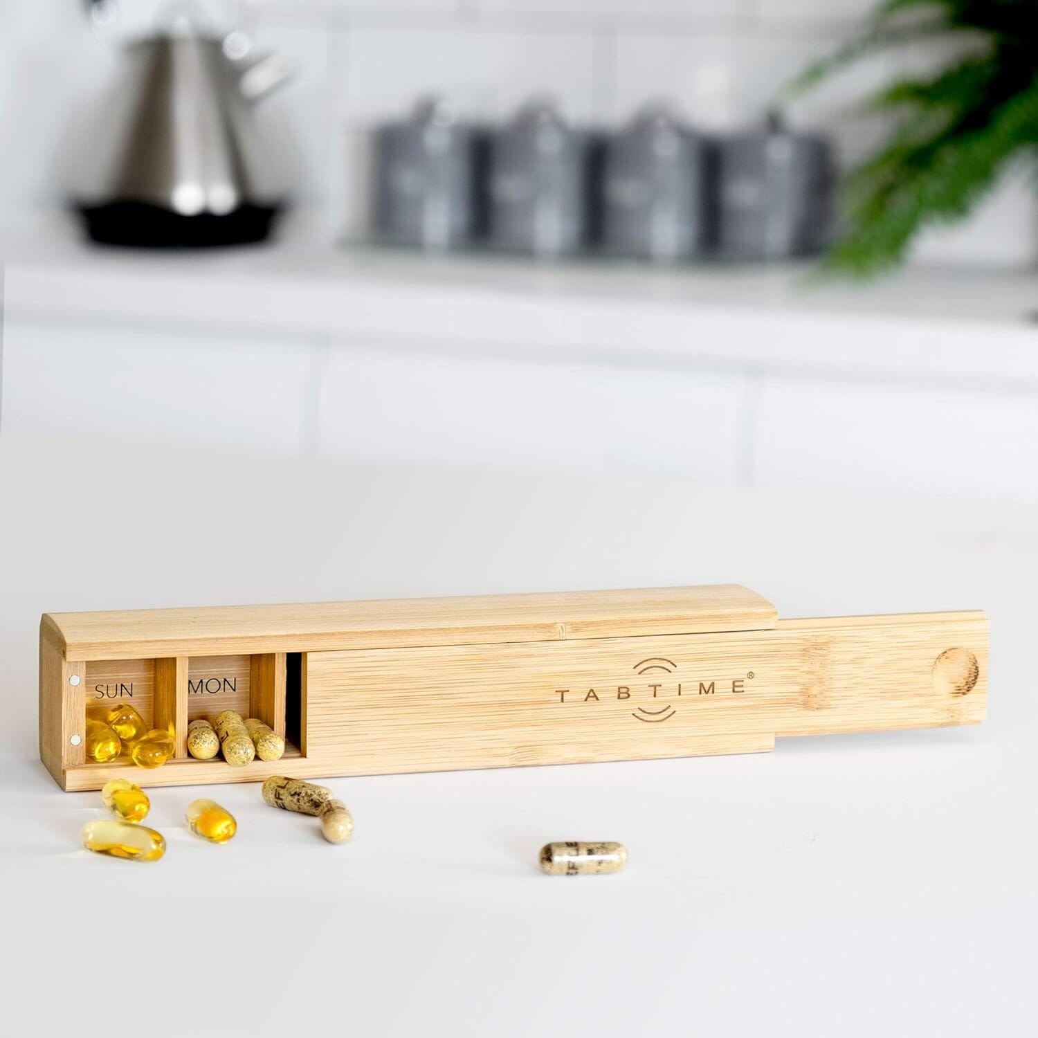 bamboo weekly pill box in a nice setting