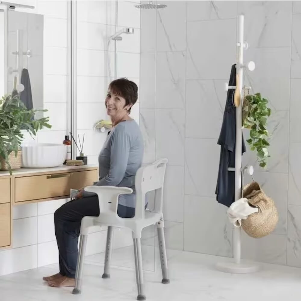 etac swift shower chair with arms grey in use
