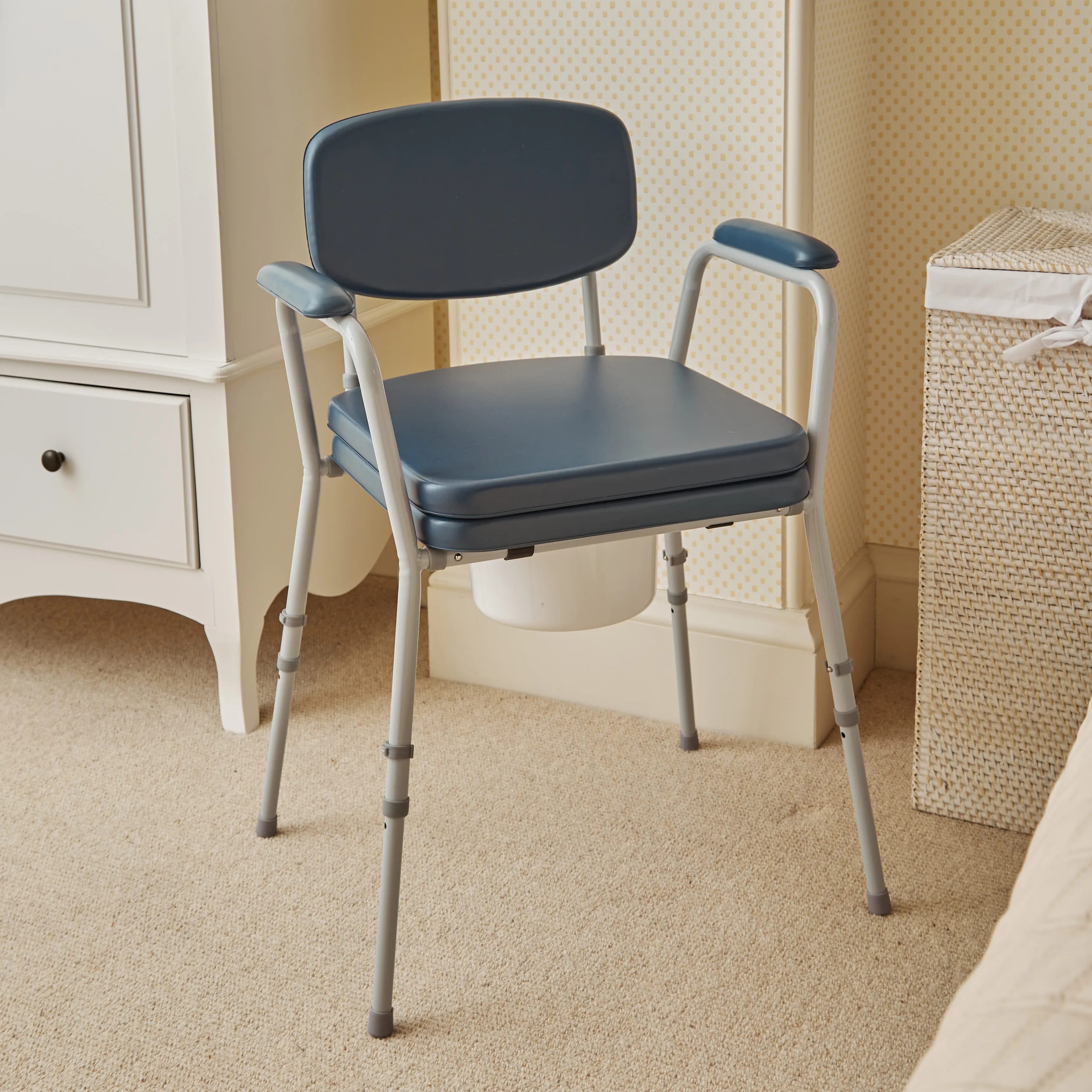 height adjustable comfort commode chair in room