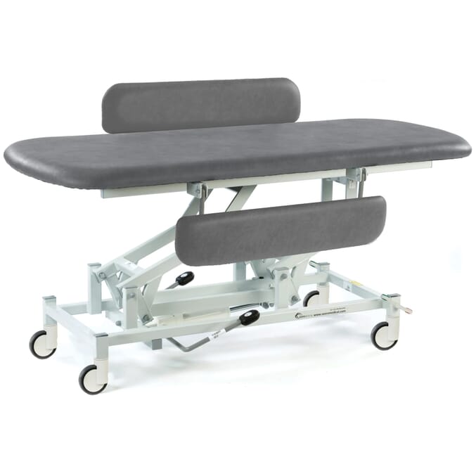 hydraulic therapy hygiene table with central locking wheels and padded side rails dark grey
