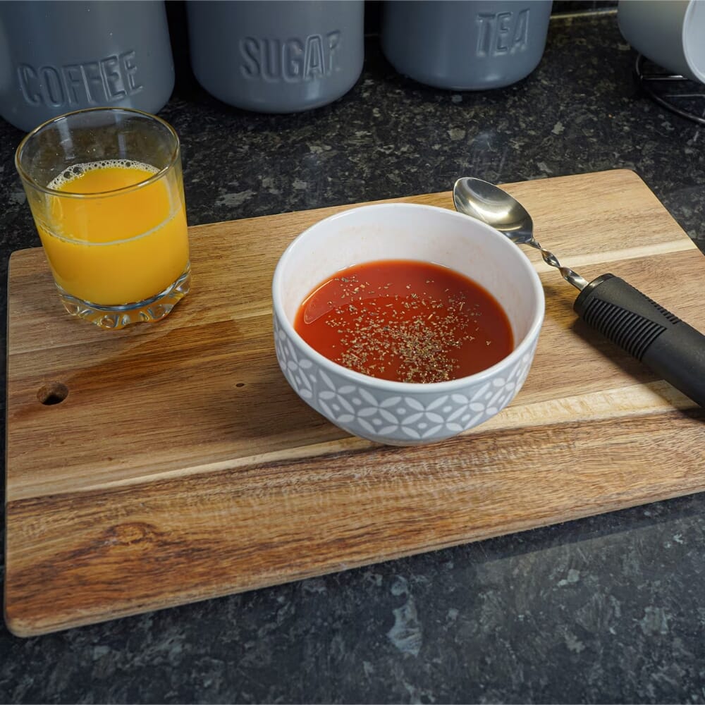 large grip bendable spoon lifestyle next to bowl
