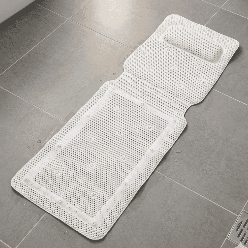 long bath mat with neckrest on floor