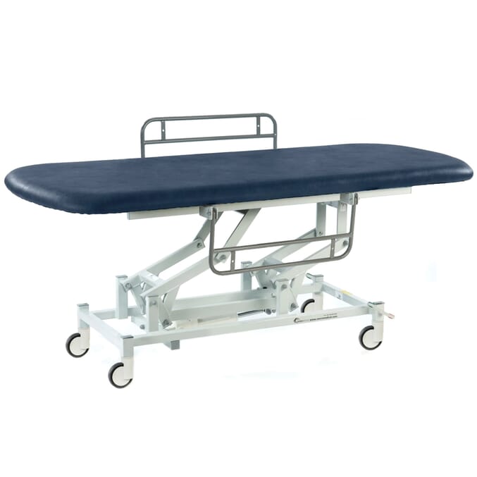 long electric therapy hygiene table with central locking wheels and side rails dark blue