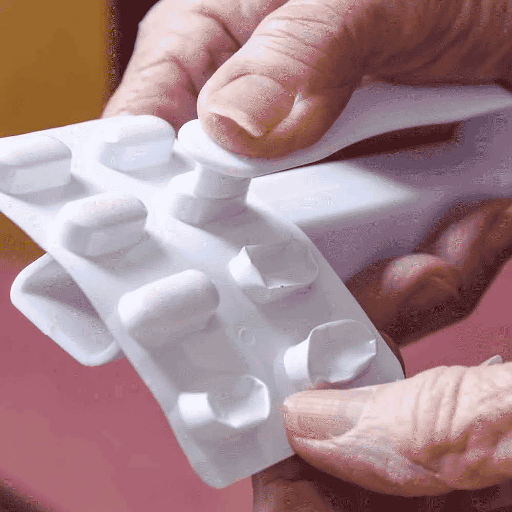 plastic pill popper in use