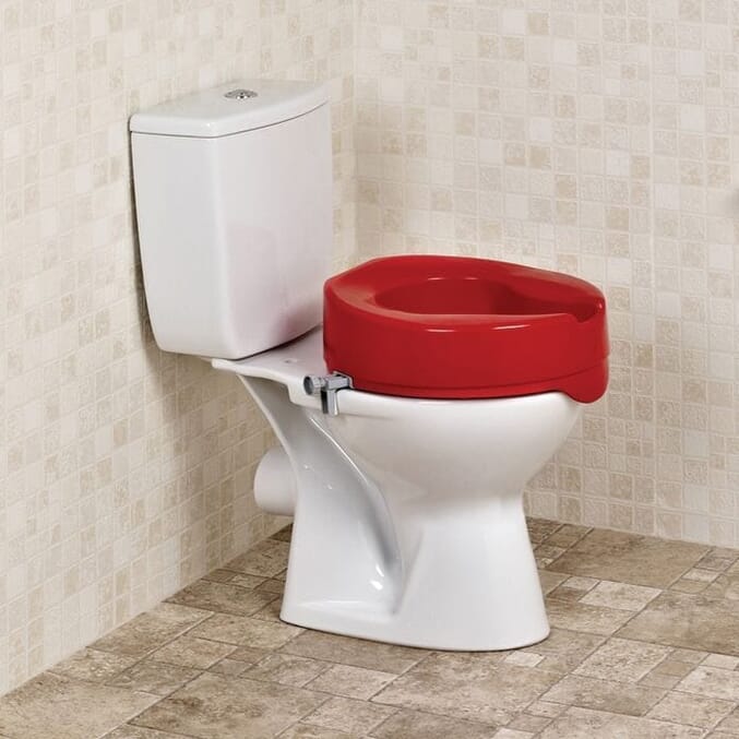 red raised toilet seat in situ