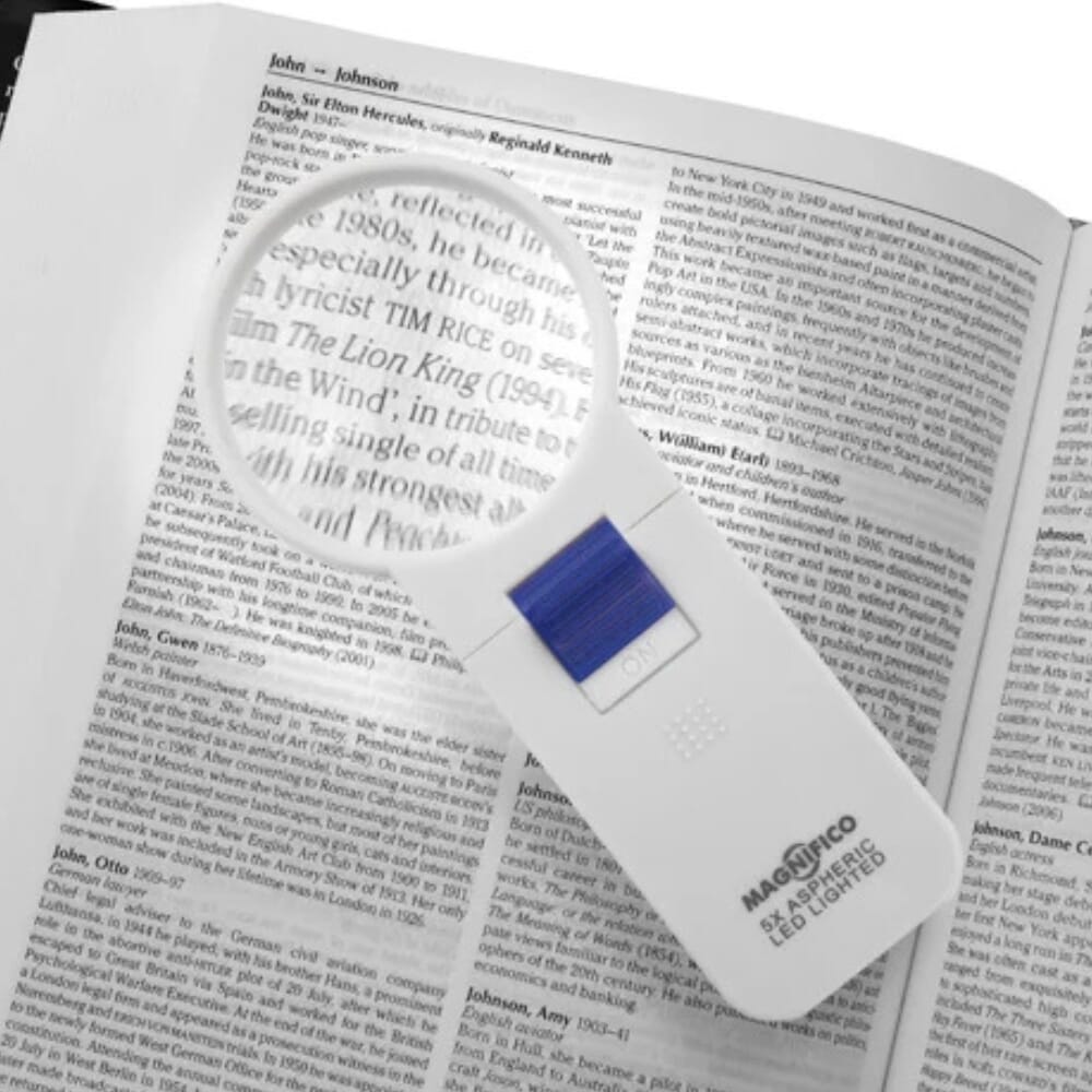 round led magnifying glass over book