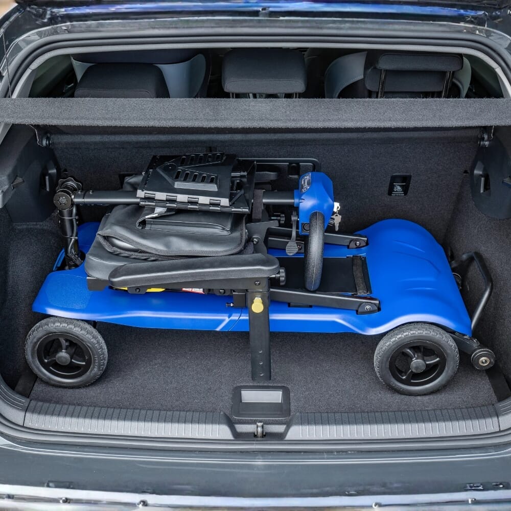scooterpac atom fold mobility scooter marine blue in back of car