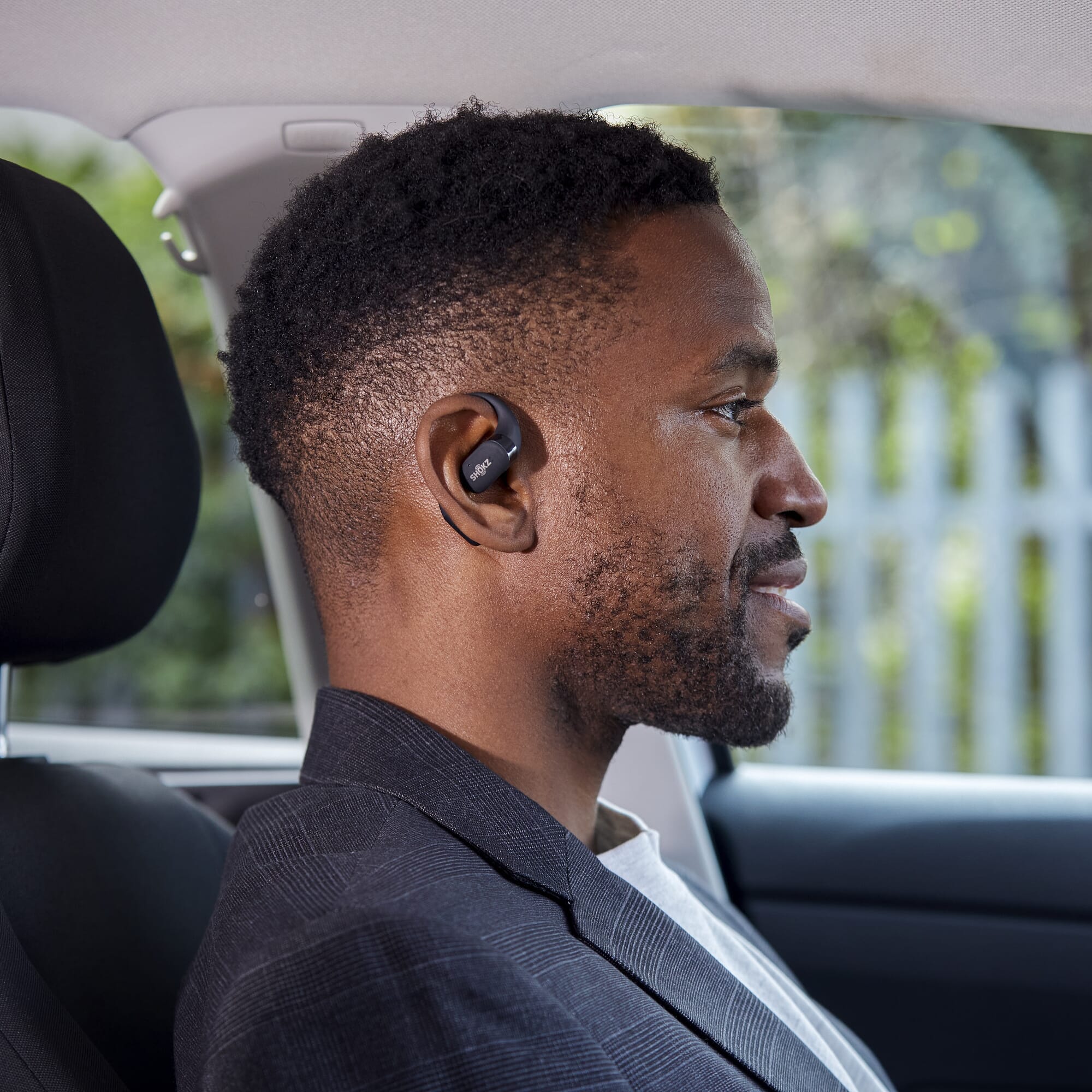 shokz openfit earbuds in use