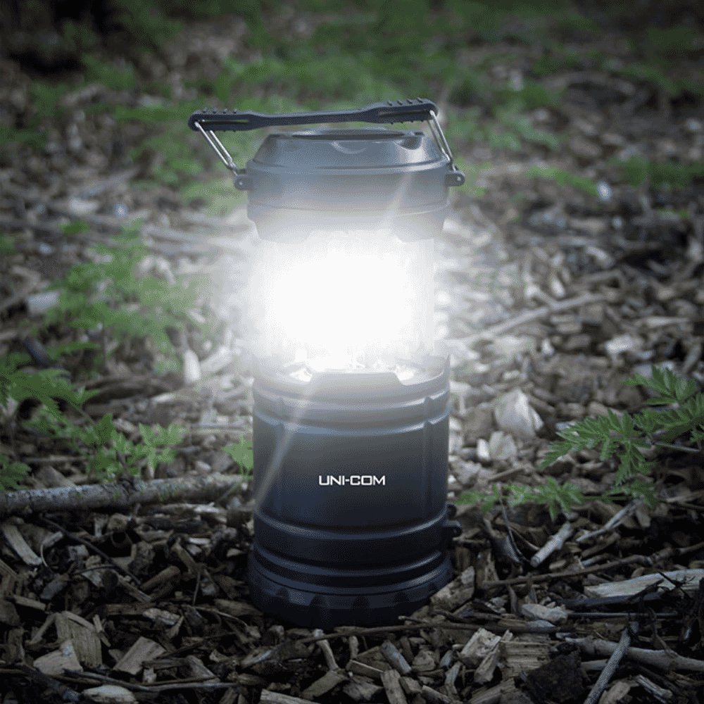 uni com spotlight and lantern in woods